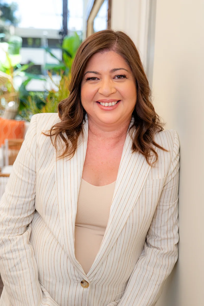 Professional headshot of Malka Borrego, founder of MB Consulting Co, smiling in a pinstripe blazer—providing fractional leadership and executive coaching in Los Angeles.